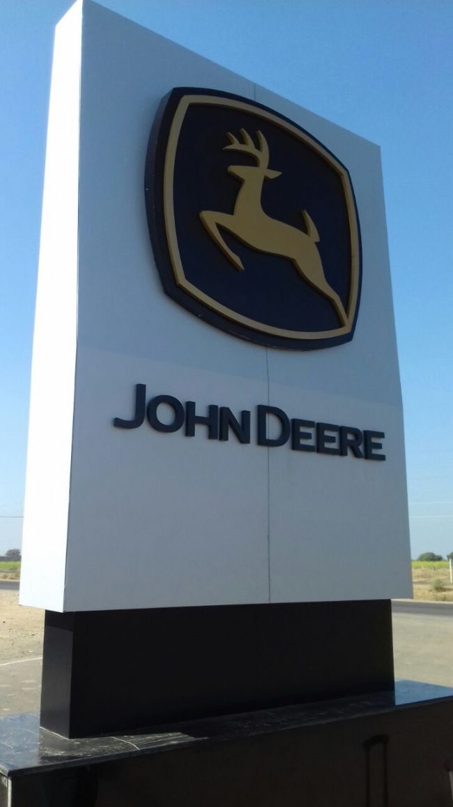 Large factory entrance metal and acrylic sign